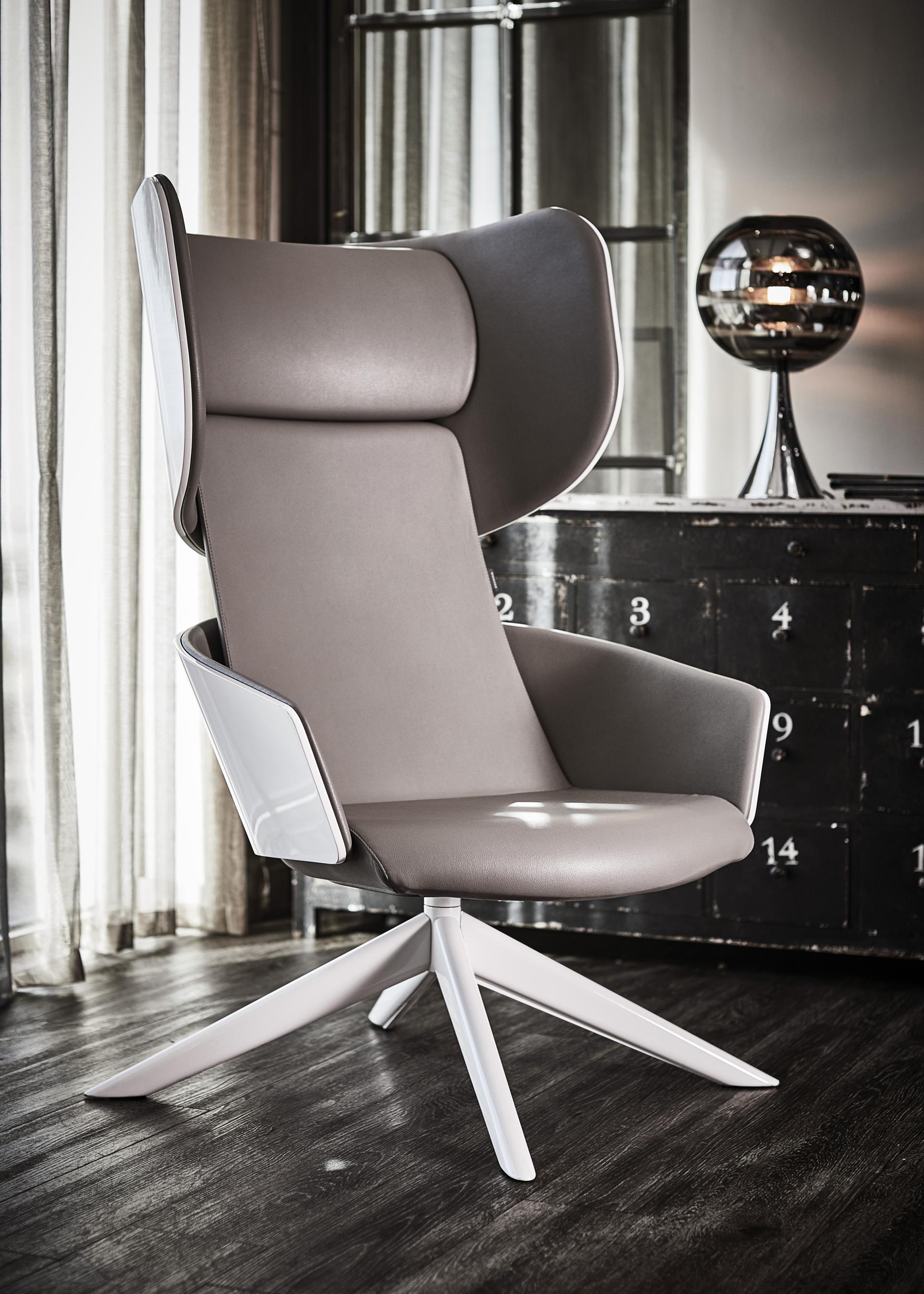 Stylish modern gray chair with high back and white accents, showcasing innovative furniture design by Gresham.