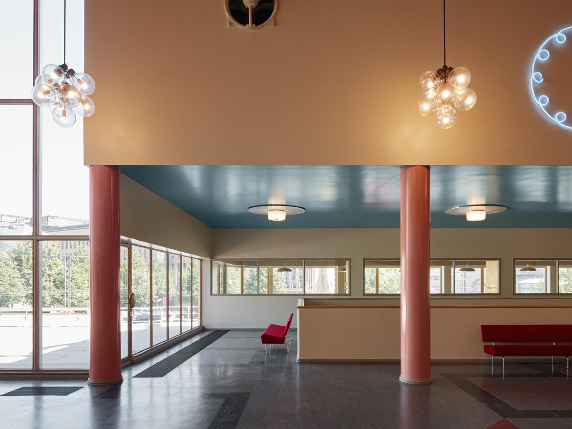 Modern interior of Helsinki's new art museum, featuring colorful design elements and large windows for natural light.