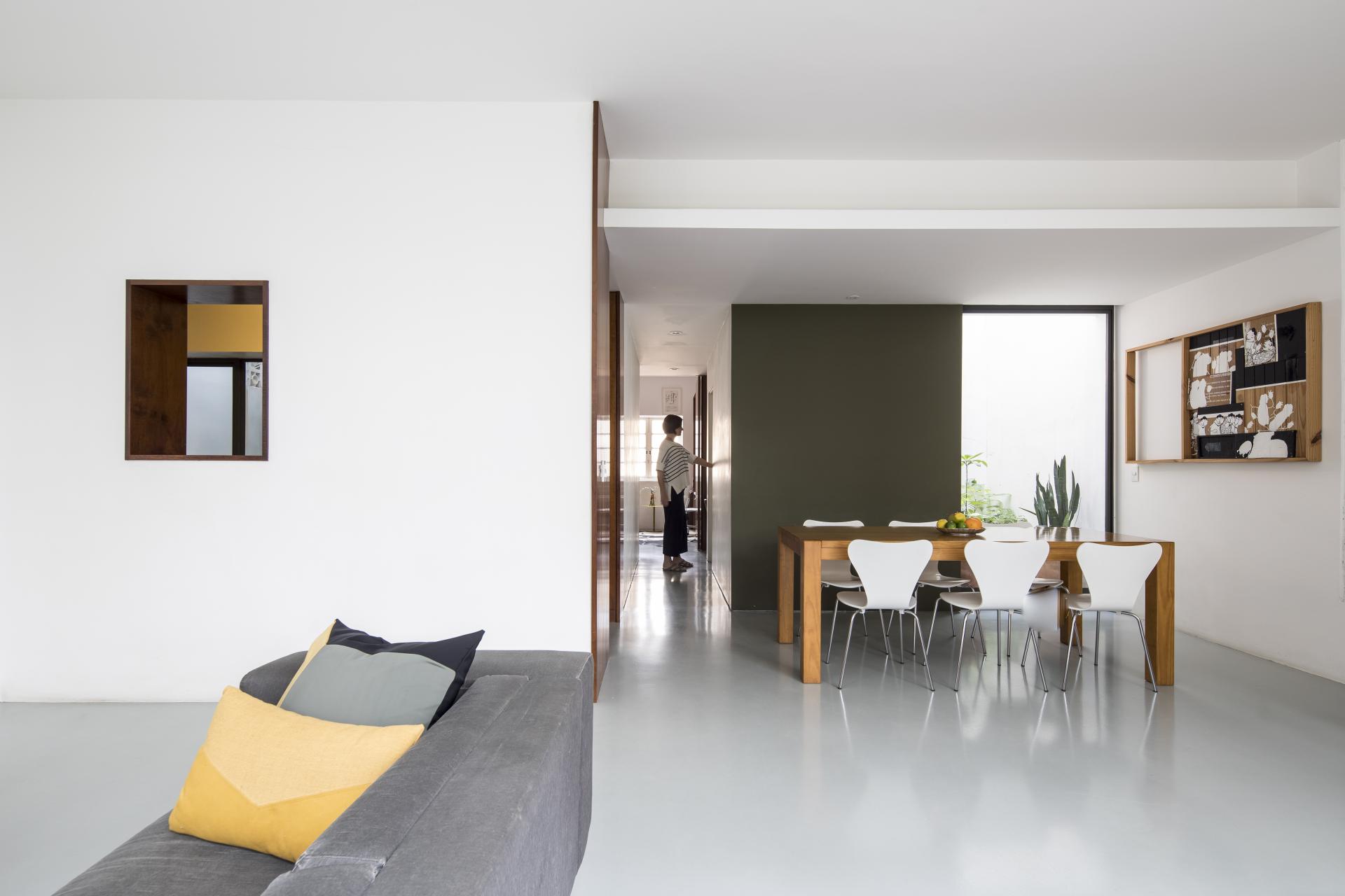 Renovated mid-century apartment in São Paulo featuring a sleek interior design, dining area, and natural light.