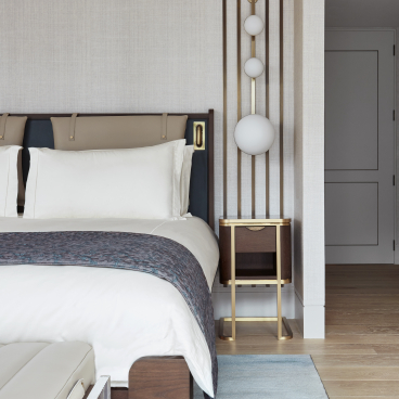 Elegant penthouse bedroom at Mandarin Oriental London, featuring a luxurious bed, stylish lighting, and modern furnishings by Joyce Wang Studio.