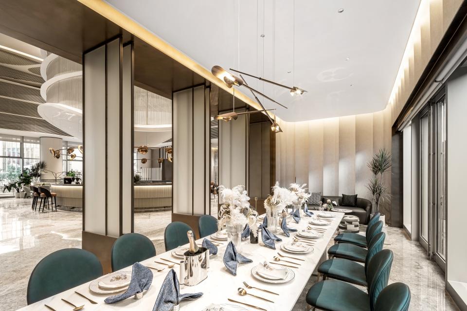 Elegant dining area in the Rhythm community centre showcasing modern design, stylish table settings, and lush greenery.