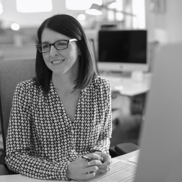 Gaynor Taylor from Mansfield Monk smiling at her desk, highlighting insights on workplace trends and future developments.