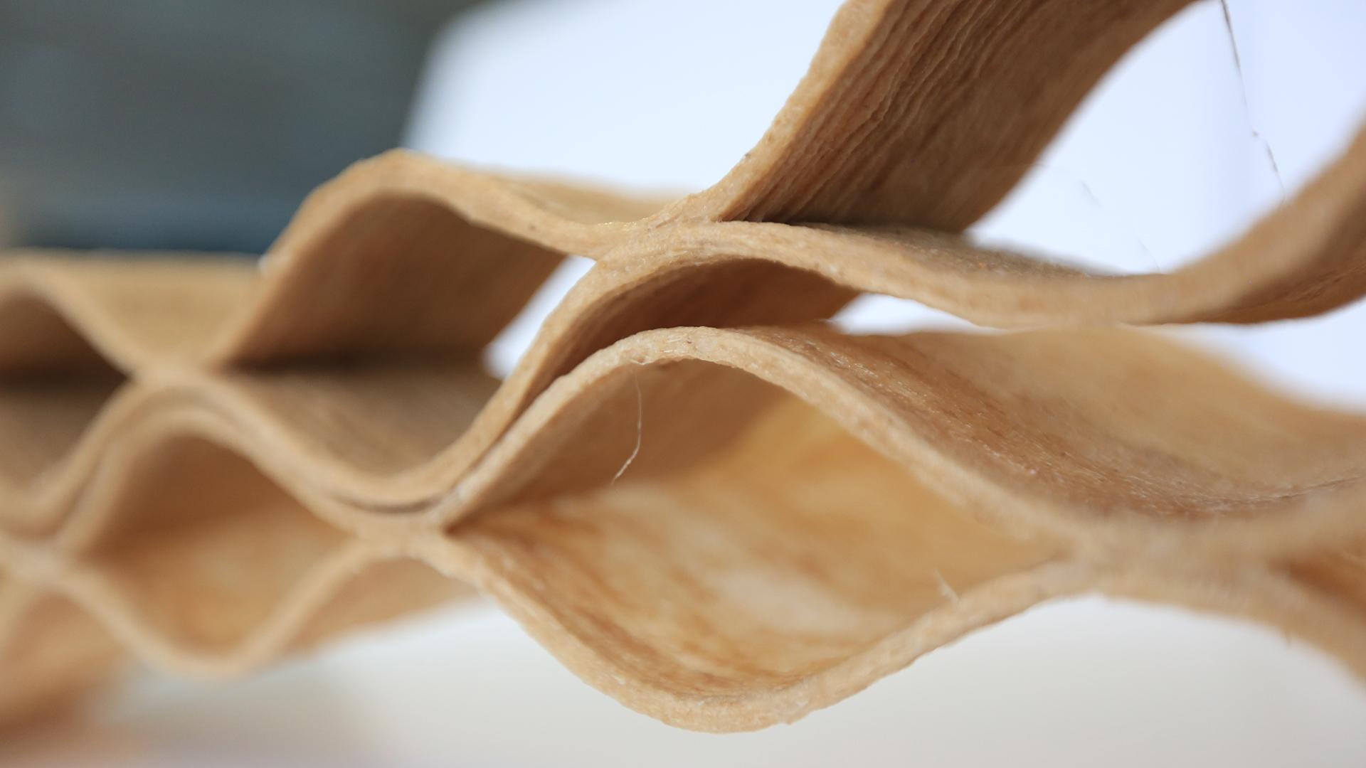 Sustainable design element featuring intricate waves of biodegradable material showcased at the Design Museum during COP26.