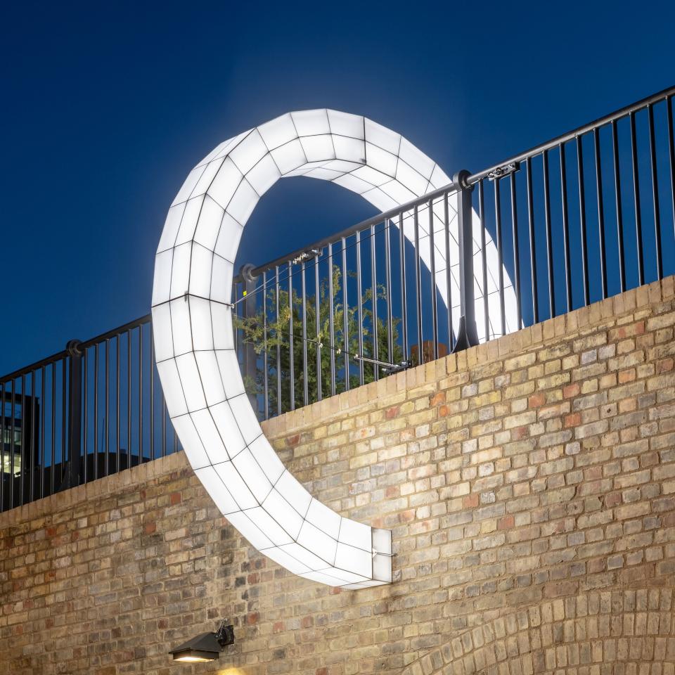 Giant sculptural light installation by Studio Mieke Meijer illuminating Coal Drops Yard at night, showcasing contemporary design.