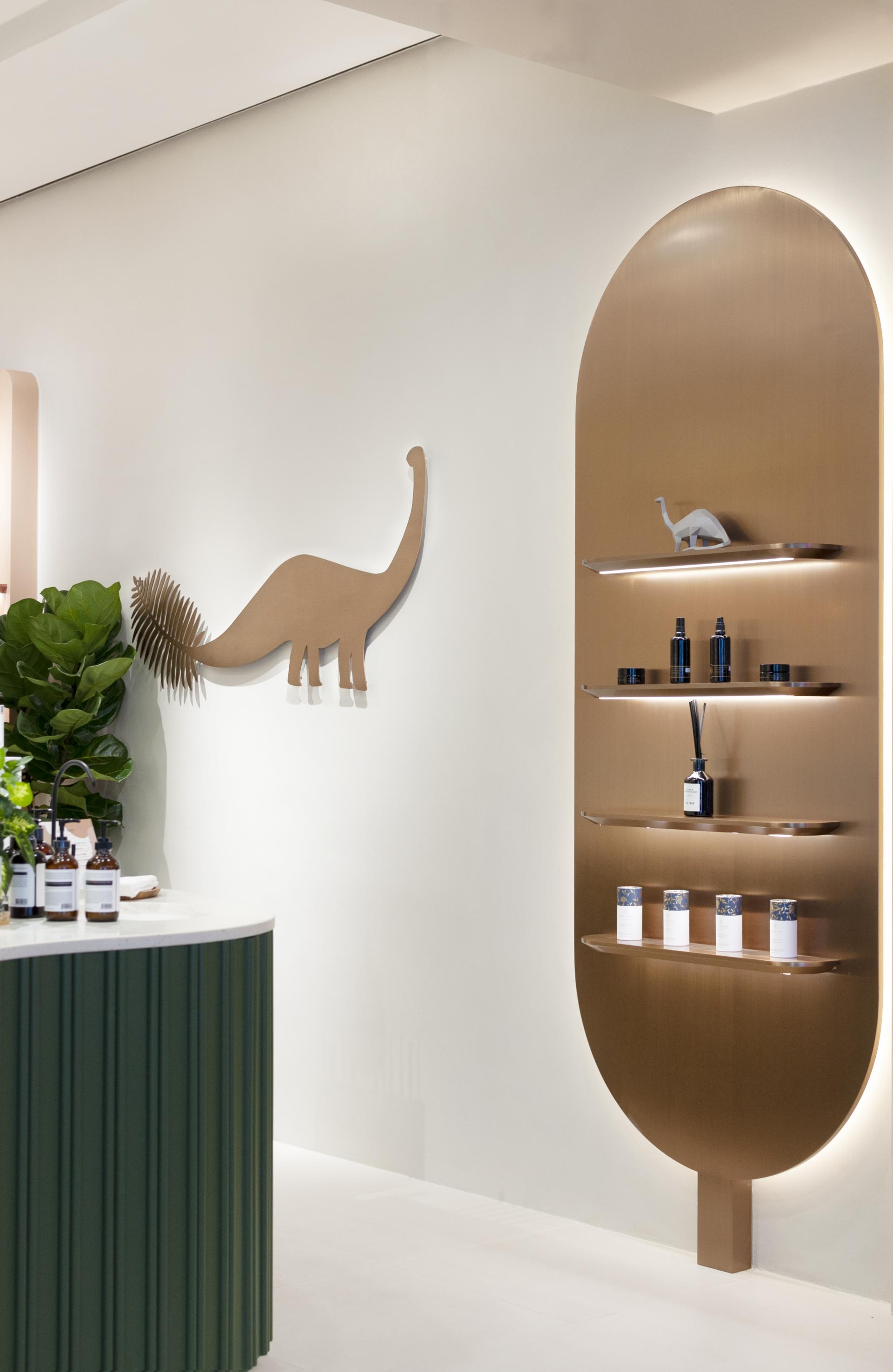 Sculptural display in a beauty store featuring organic skincare products and playful dinosaur decor elements.