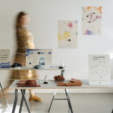 Exhibits showcasing sustainable materials and color concepts in circular design, featured in a bright, collaborative space.
