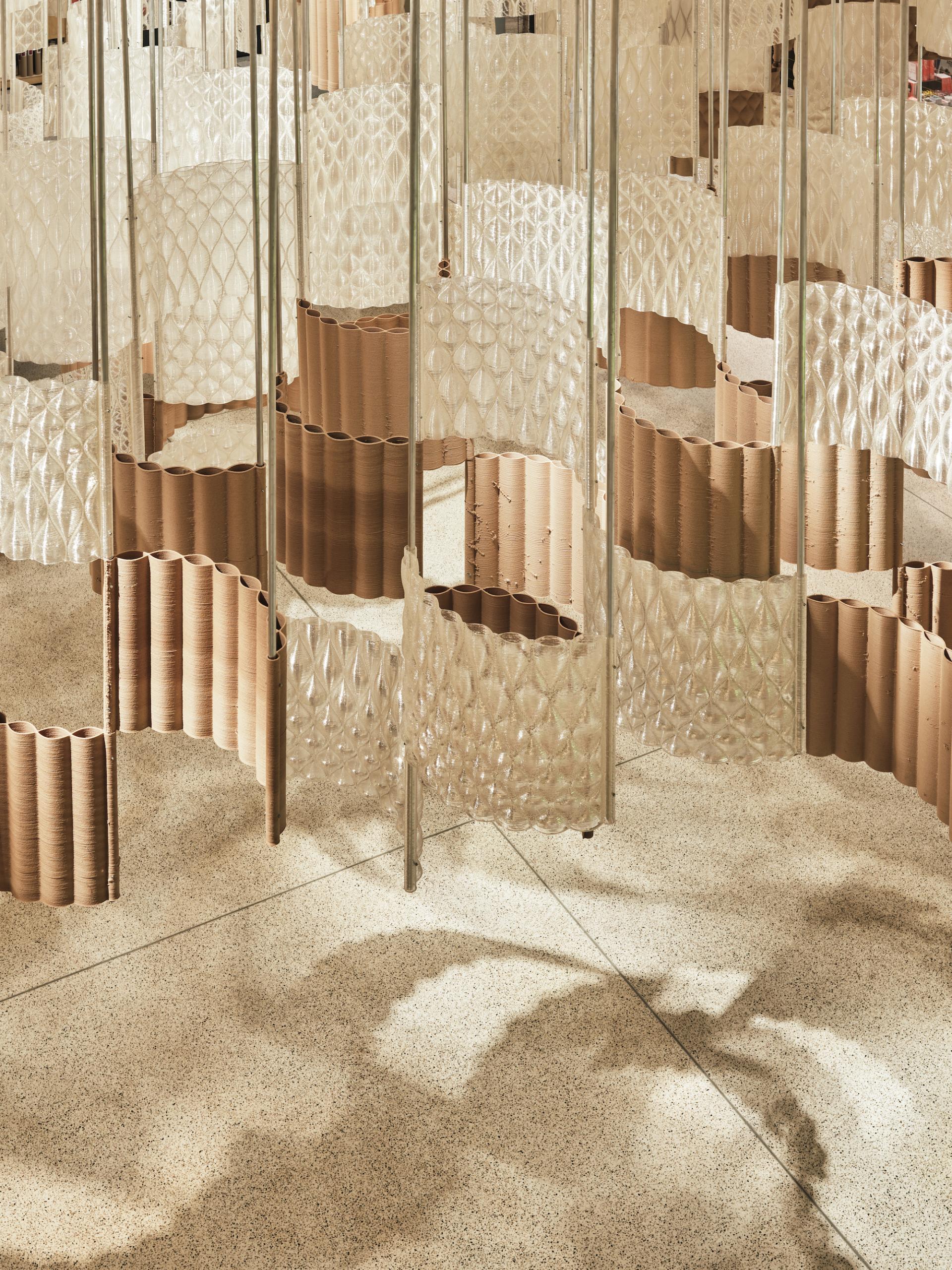 Intricate installation of transparent and brown modular designs creating a unique spatial experience at the Design Museum during COP26.