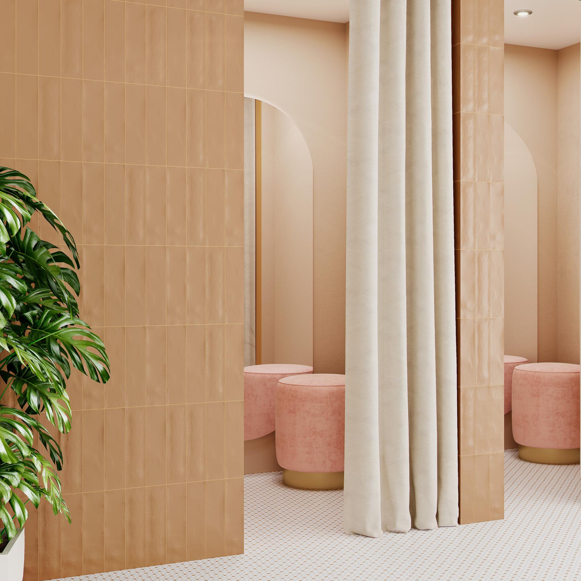 Stylish interior featuring peach tiles, soft pink stools, and decorative plants, showcasing contemporary design trends in Spanish tile.