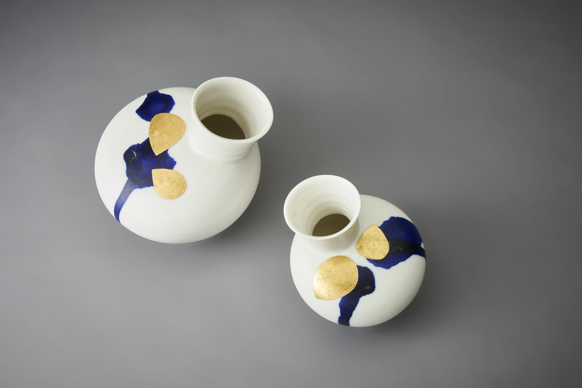 Elegant ceramic vases featuring blue and gold patterns, embodying contemporary craft and design principles.