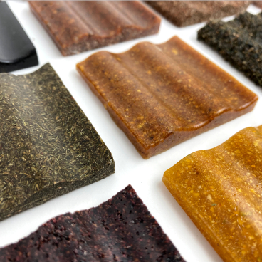 Colorful, textured biomaterials samples arranged on a surface, showcasing innovative designs in sustainable material development.