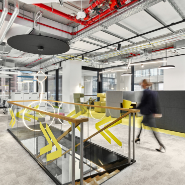 Modern office interior featuring flexible workspaces and collaborative areas designed for efficiency during and after the pandemic.