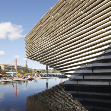 Striking exterior of V&A Dundee designed by Kengo Kuma, showcasing layered architecture reflecting on the water.