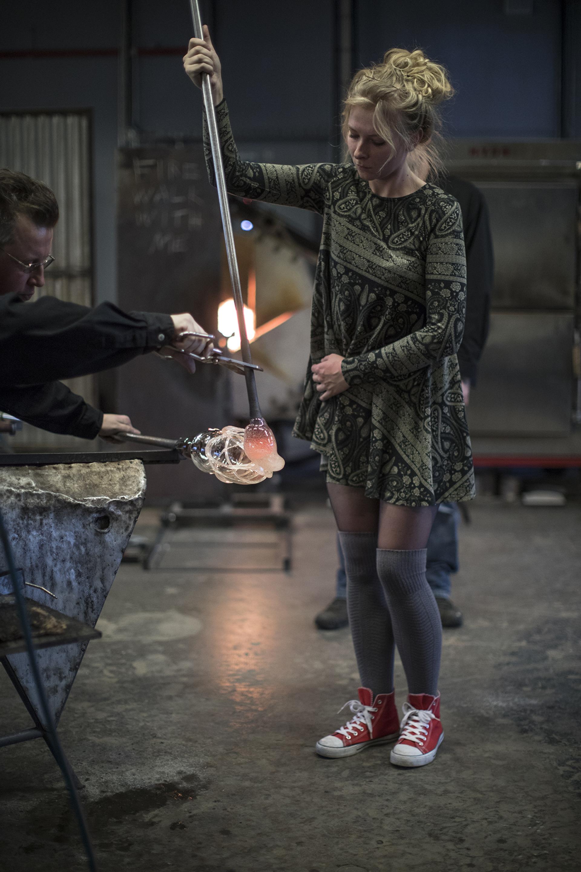 A glassblower demonstrates the art of glassmaking at the Glass Factory in Småland, showcasing creativity and craftsmanship.