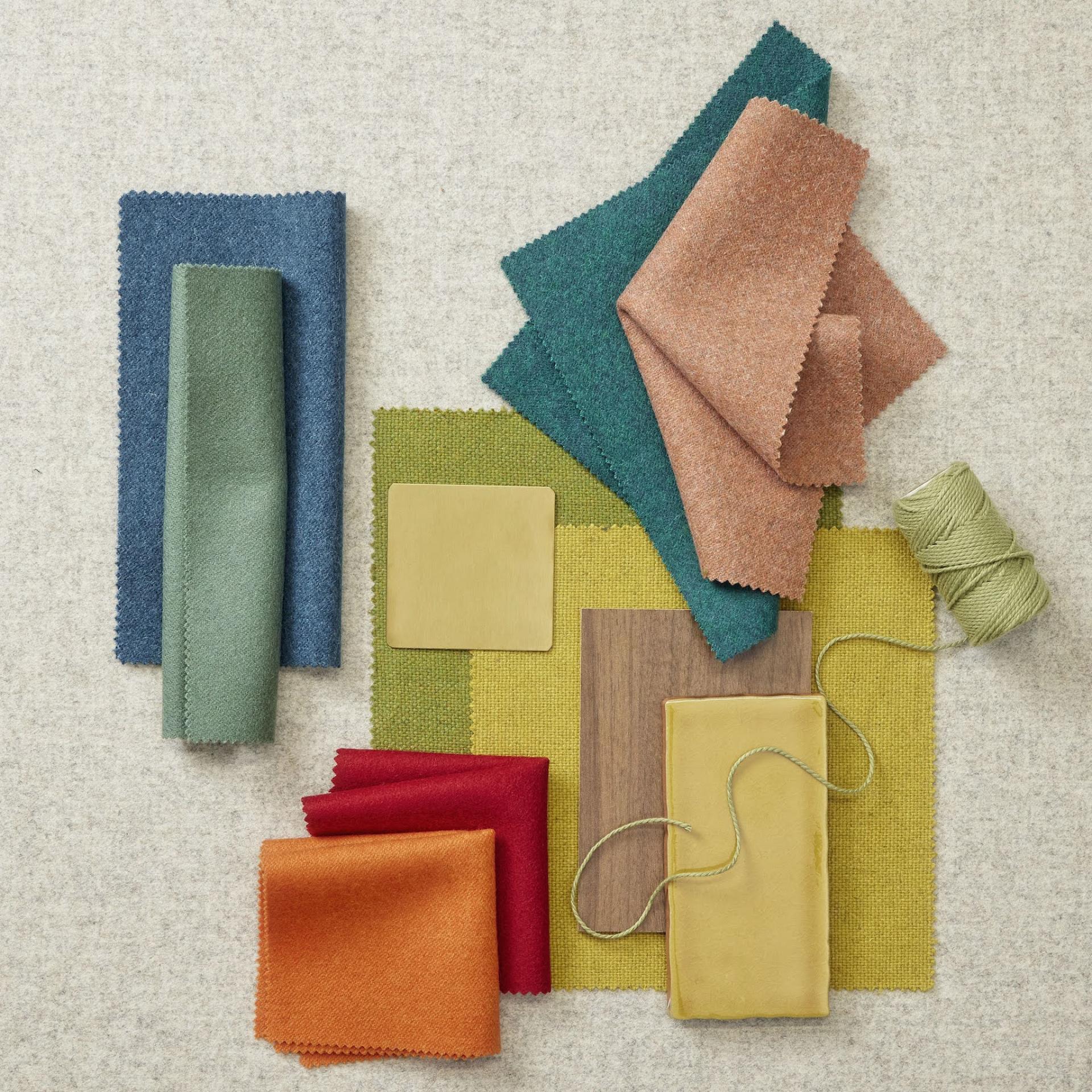 A vibrant selection of fabric swatches and materials, showcasing colors and textures for interior design inspiration.