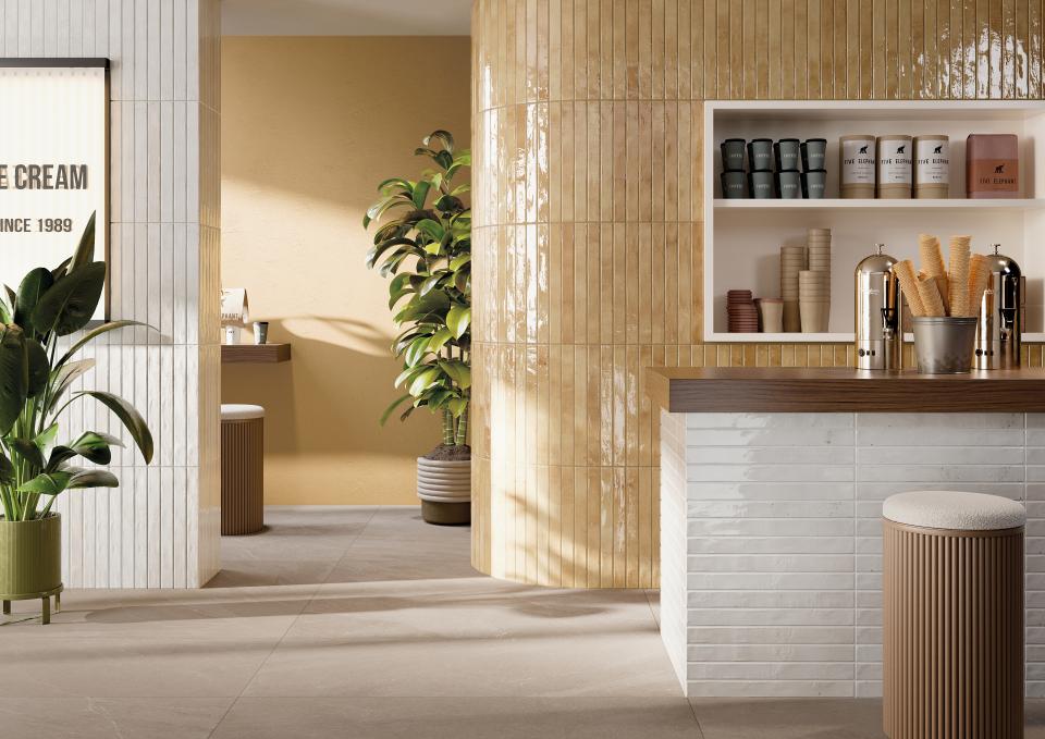 Stylish interior featuring Grestec's Mastreta elongated tiles, vibrant plants, and a contemporary counter design.