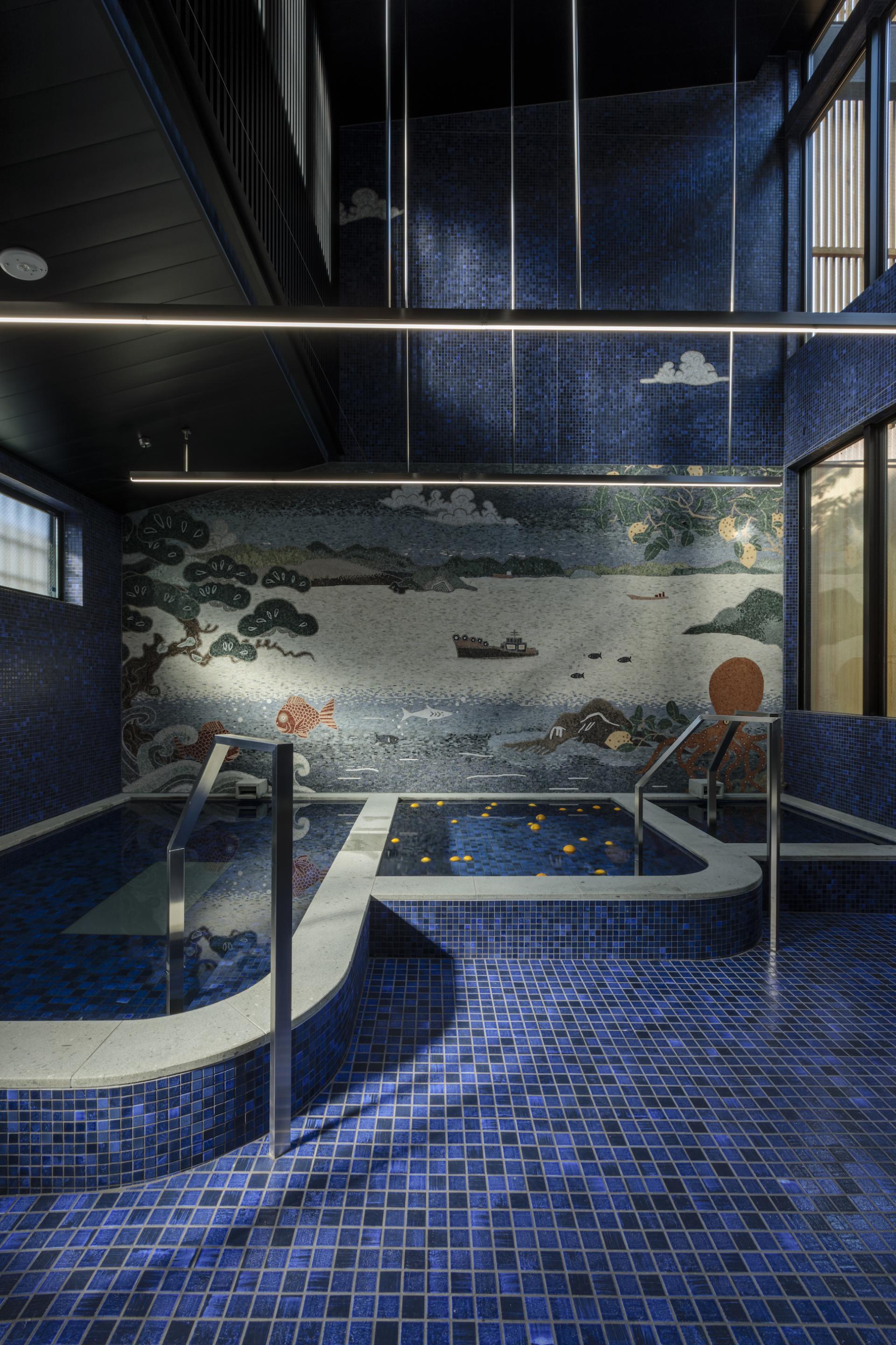 Tranquil ryokan interior at Azumi Setoda featuring blue tiled bath, mosaic art, and serene atmosphere for modern travelers.