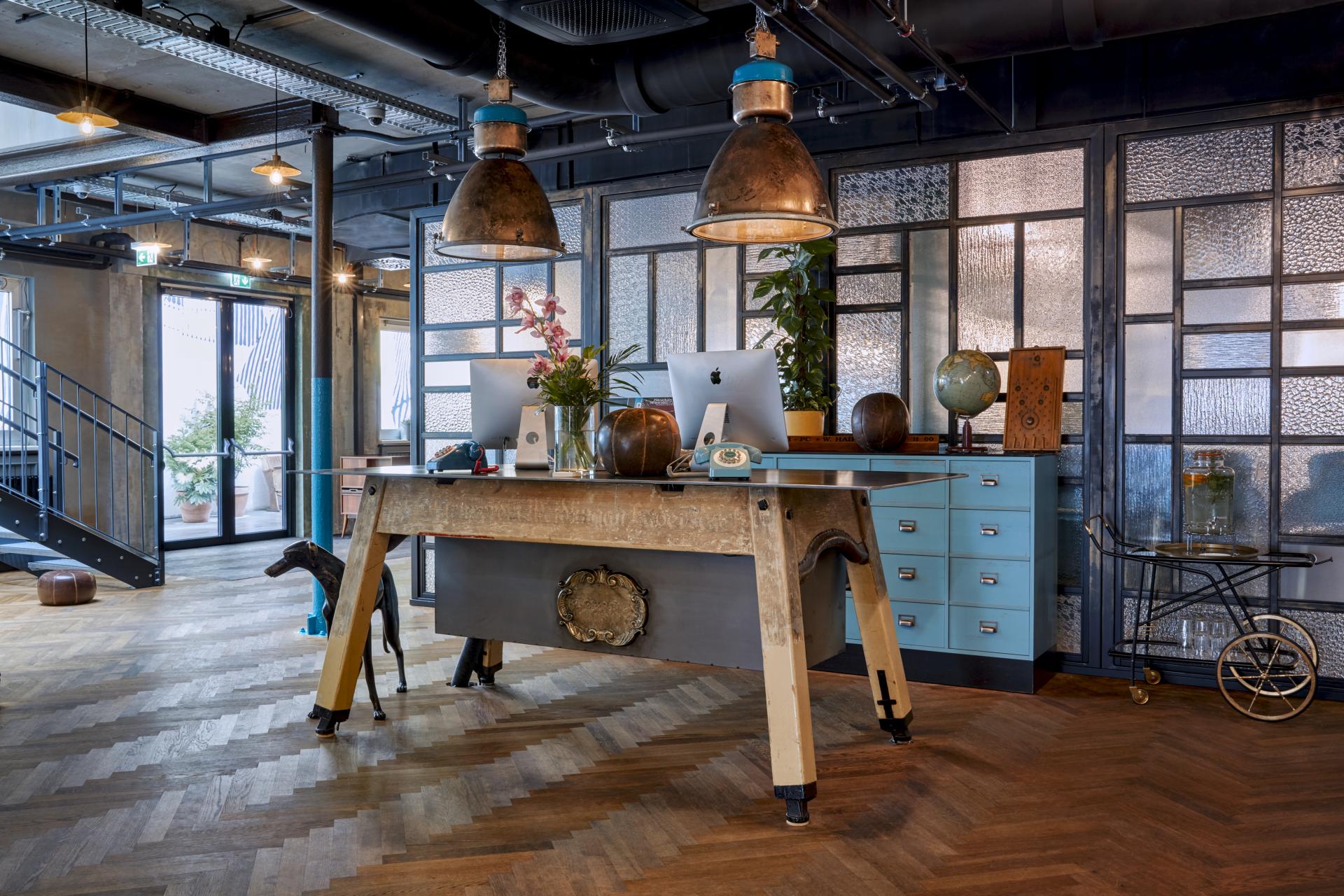 Welcoming reception area of Max Brown Hotel in Vienna's Neubau, featuring stylish decor and creative design elements.