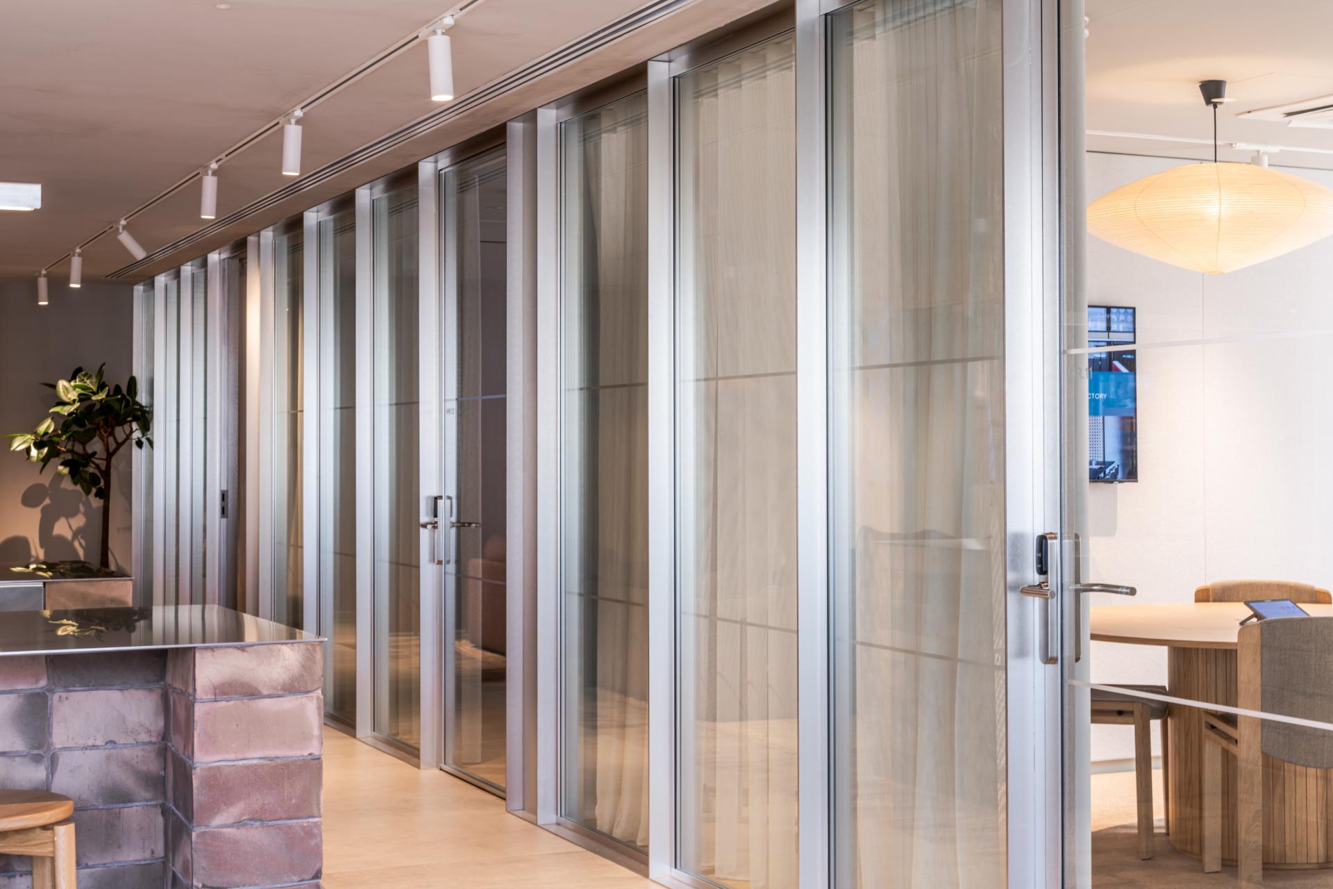 Modern glass-encased meeting rooms in a flexible workspace design showcasing The Office Group's commitment to wellbeing at Chancery House.