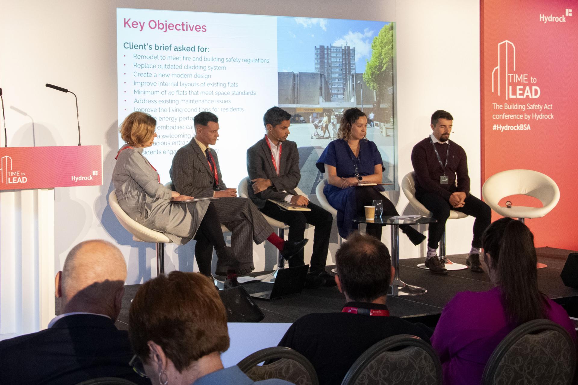 Panel discussion at Hydrock's conference focusing on fire safety and building regulations, featuring industry experts and data-driven solutions.