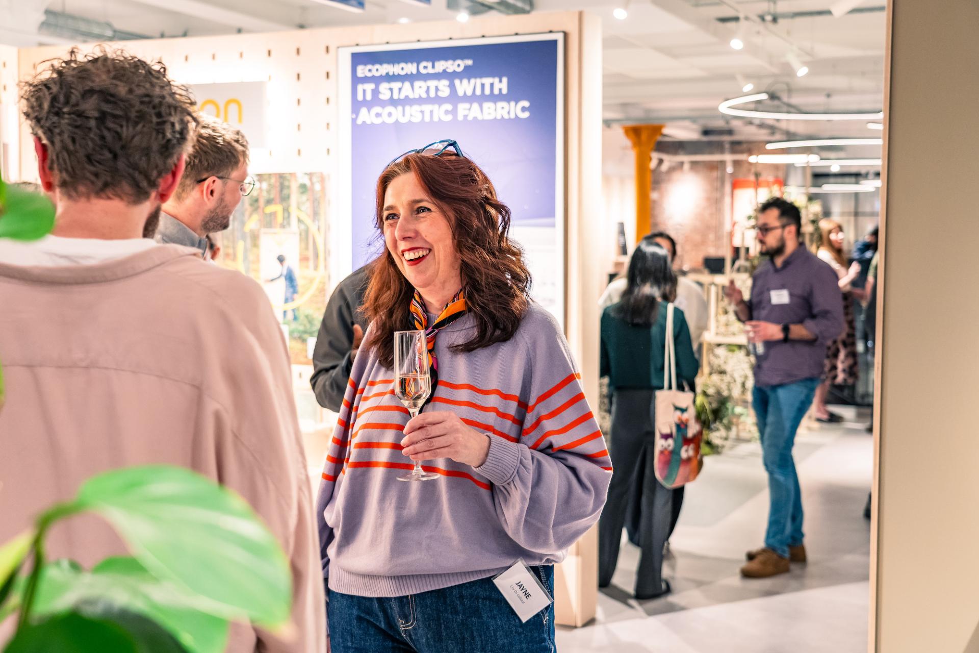 People networking at a seminar - woman wears a purple jumper