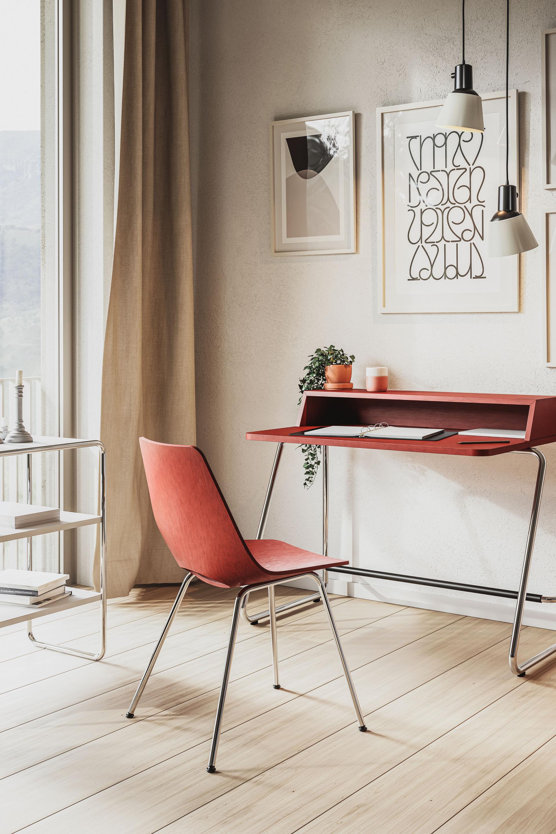 Elegant Triennale S 661 chair with a red moulded plywood seat, positioned next to a modern desk in a bright interior.