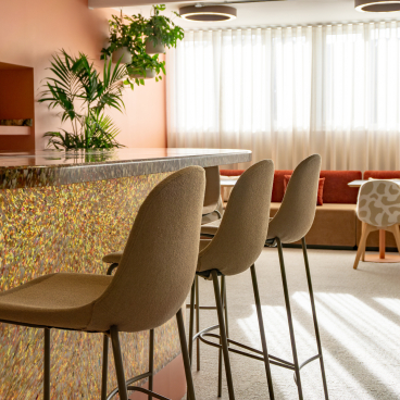 Modern seating area in the Liz Hickson Academy, featuring colorful decor and natural light for collaborative well-being.