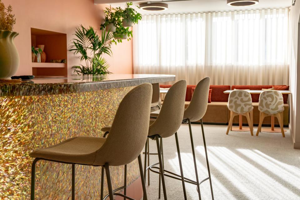 Modern seating area in the Liz Hickson Academy, featuring colorful decor and natural light for collaborative well-being.
