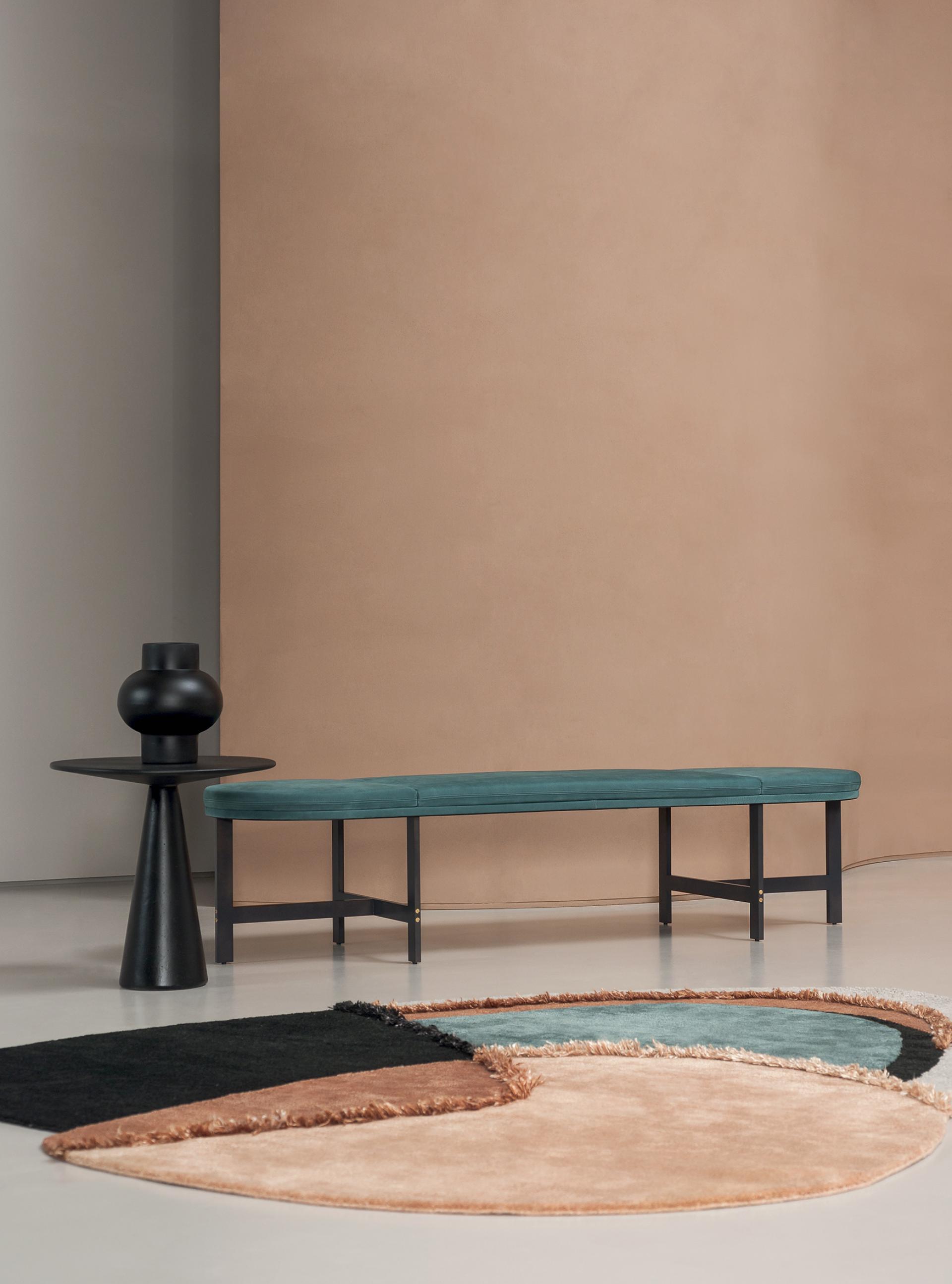 Contemporary seating and a geometric rug create a luxurious design aesthetic in a minimalist setting.