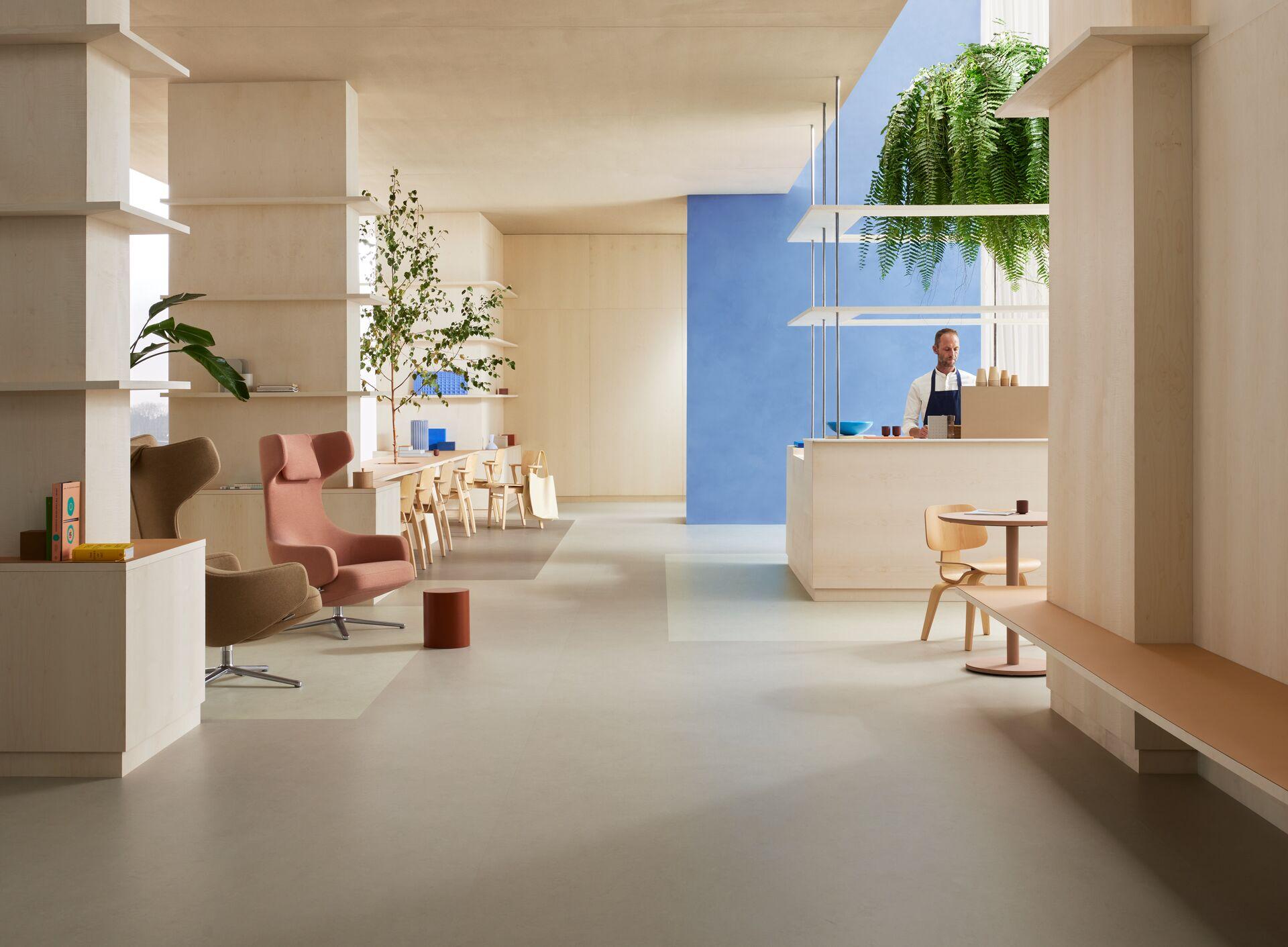 Contemporary interior featuring Forbo's Marmoleum Solids flooring, stylish seating, and natural elements in a bright space.