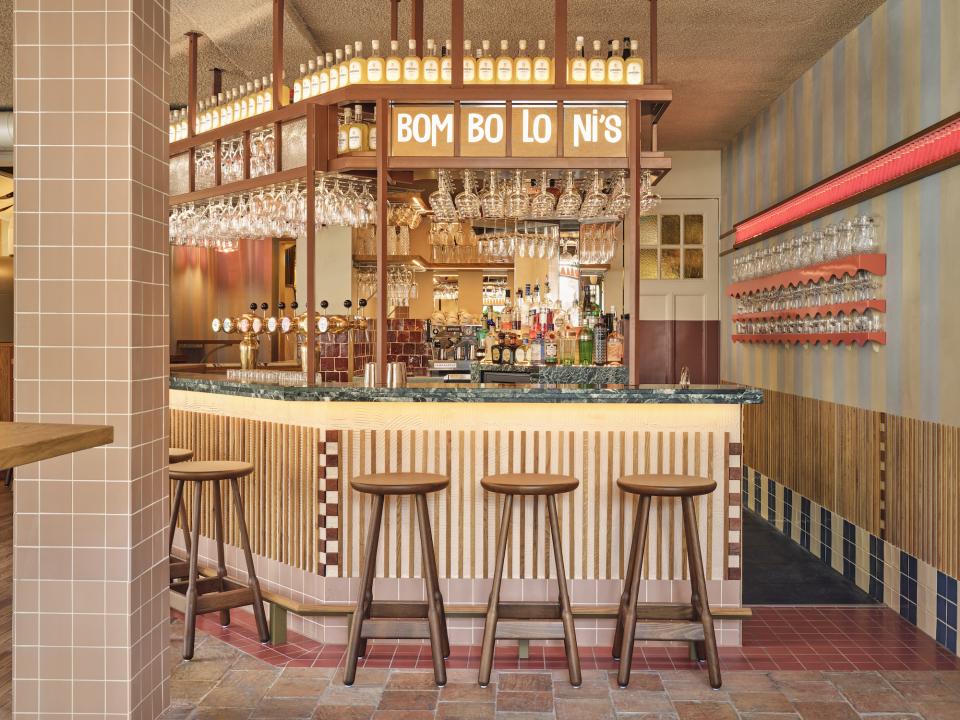 Stylish bar area of Volare trattoria, featuring colorful decor and vintage-inspired design reminiscent of the Amalfi Coast.