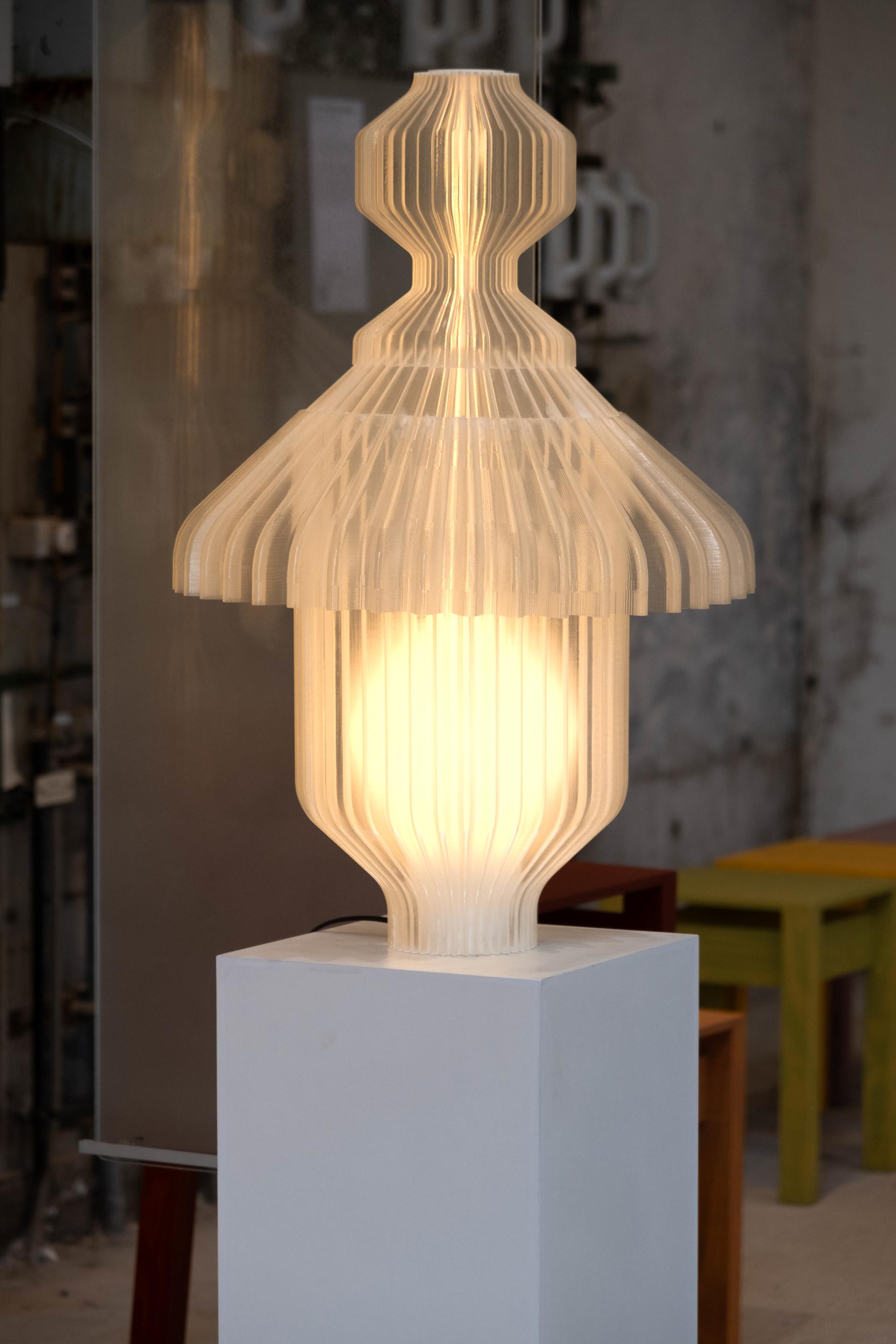 Modern lamp design with layered, transparent materials, showcasing innovative Dutch craftsmanship at Dutch Design Week 2024.
