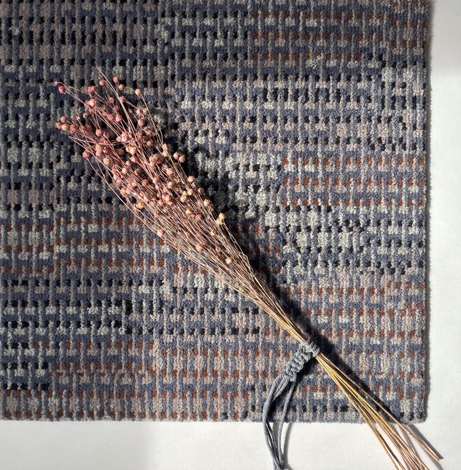 Macramé Collection carpet by Newhey Carpets, featuring a textured pattern, accompanied by dried flowers for a natural touch.