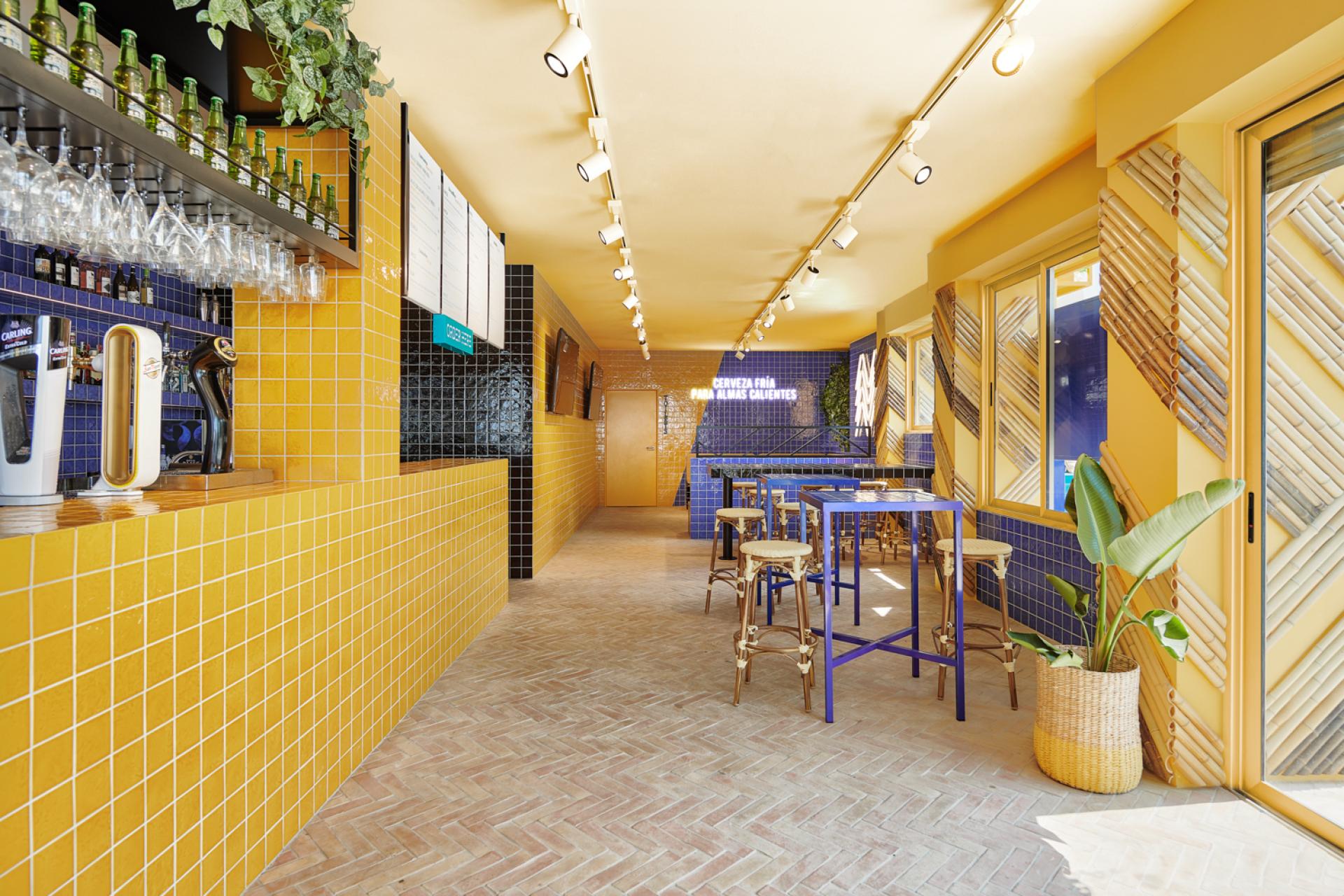 Brightly designed interior of Bar TORÖ in Ibiza, featuring Mediterranean-inspired tiles and stylish seating arrangements.