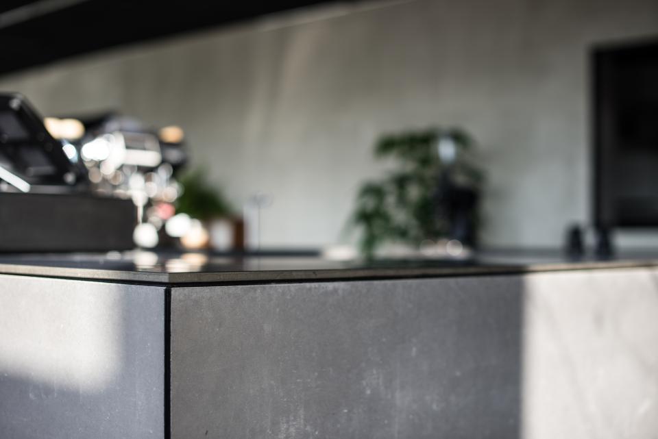 Sleek, minimalist counter at HOP's Public Space in Amsterdam, highlighting industrial design and modern aesthetics.