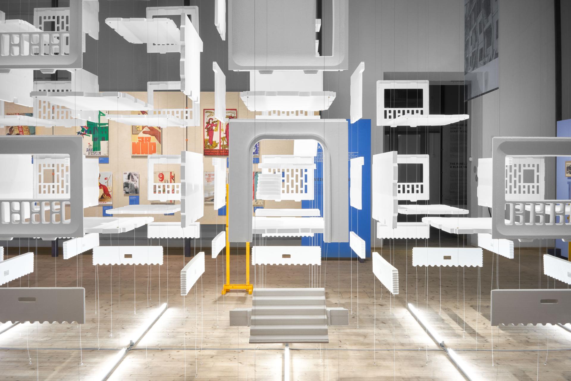 Abstract installation of hanging concrete panels at ArkDes, highlighting the legacy of concrete in urban design.