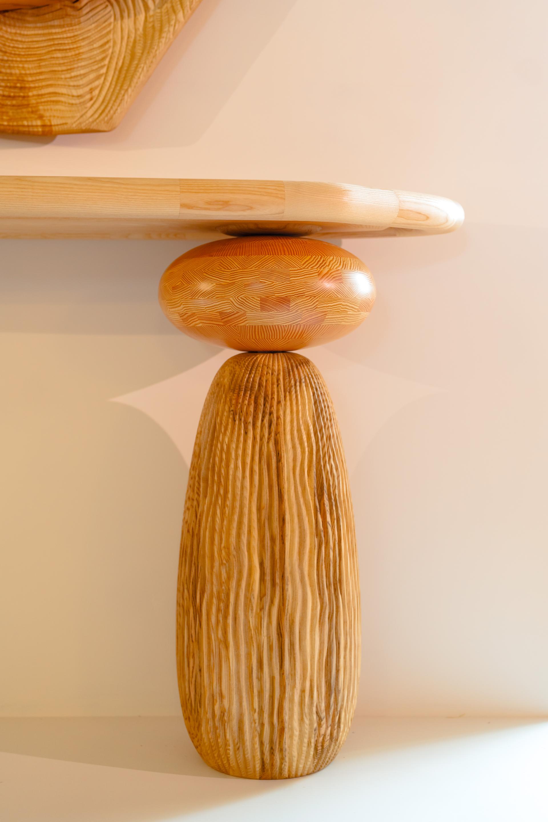 Unique wooden furniture leg designed by Jan Hendzel, showcasing intricate patterns and traditional craftsmanship techniques.