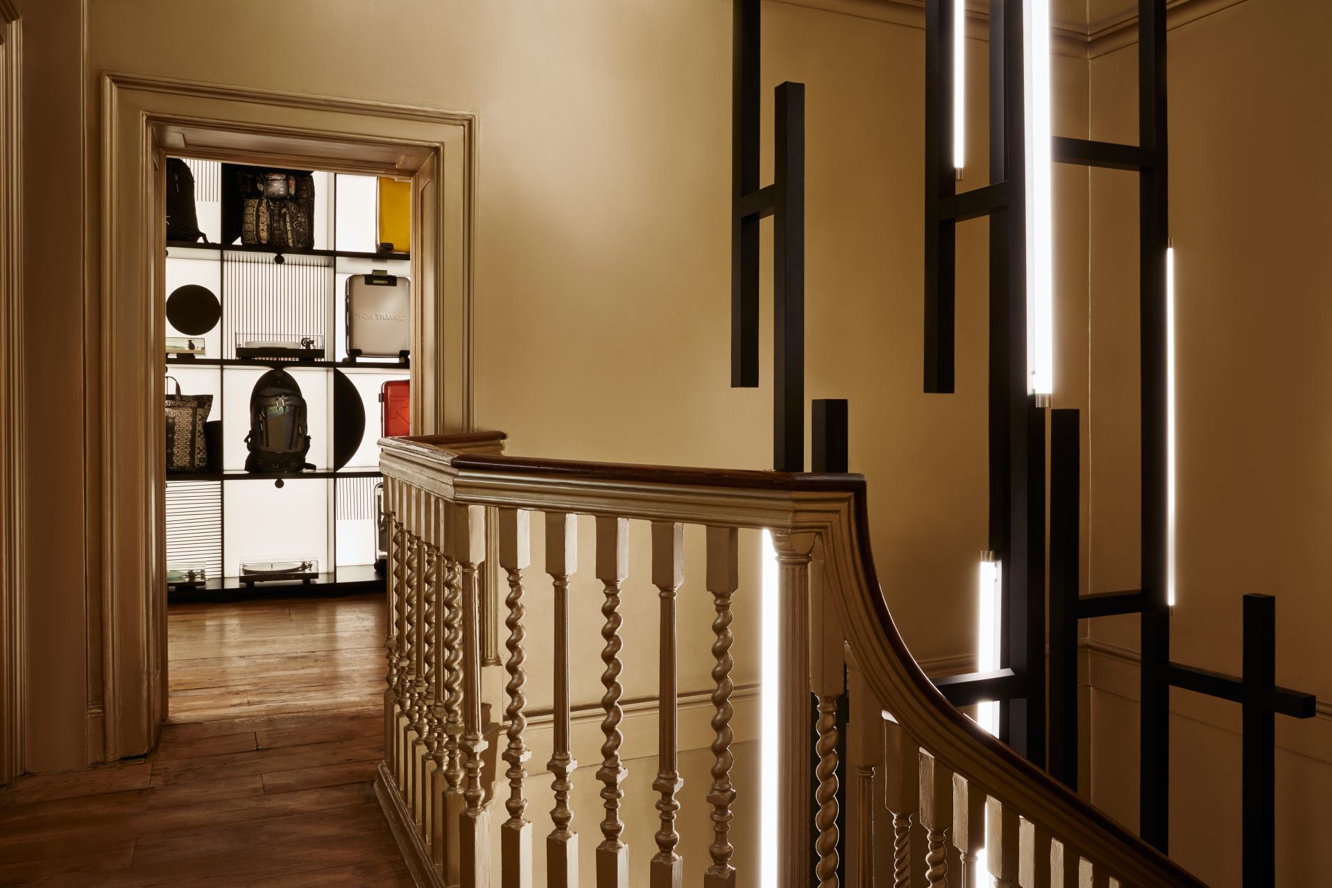 Luxurious interior lighting design by Nulty enhances the staircase at Browns, showcasing stylish accessories in the background.