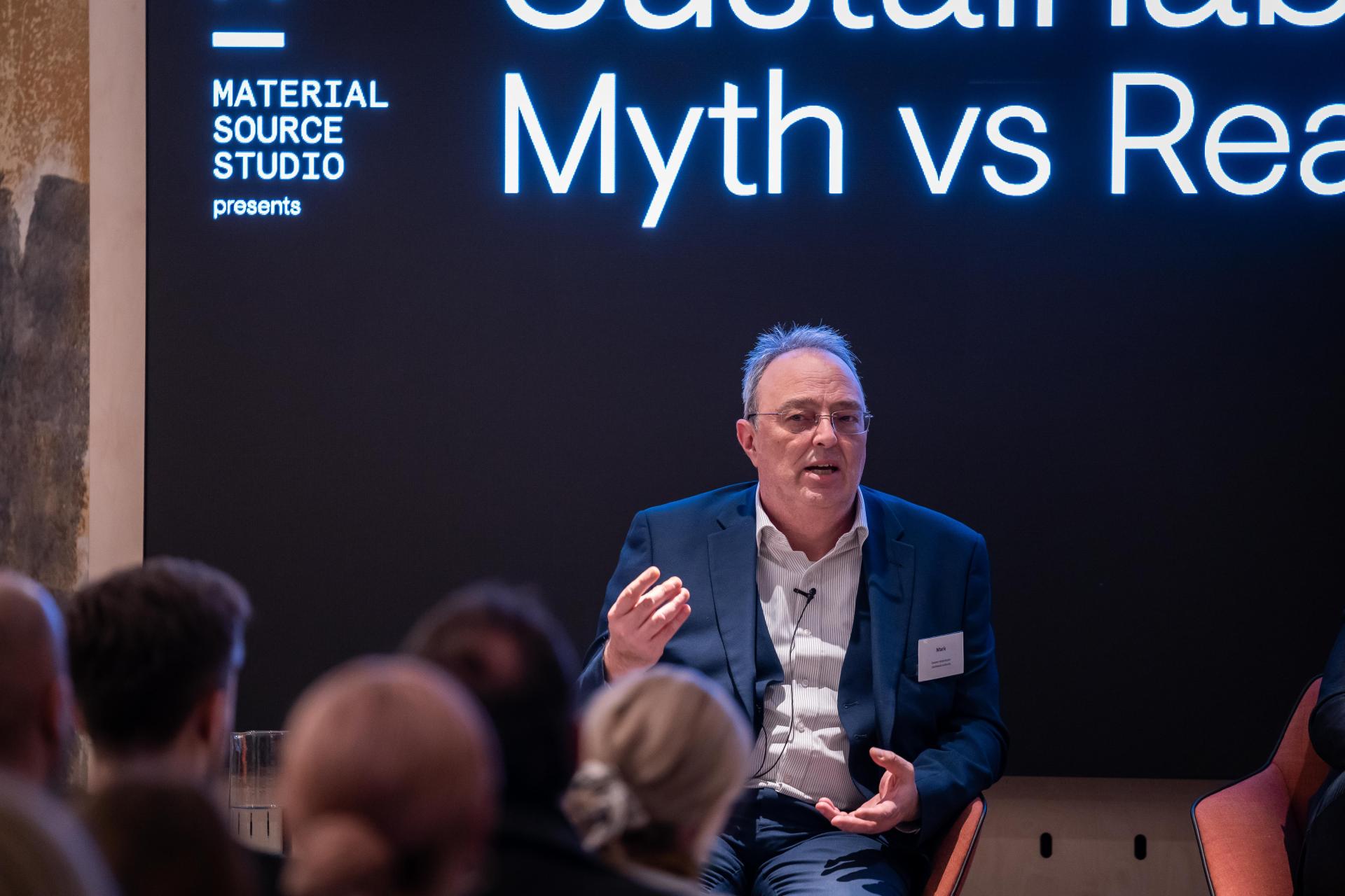 Speaker discussing sustainability during Material Source Studio seminar, with "Sustainability: Myth vs Reality" displayed in the background.