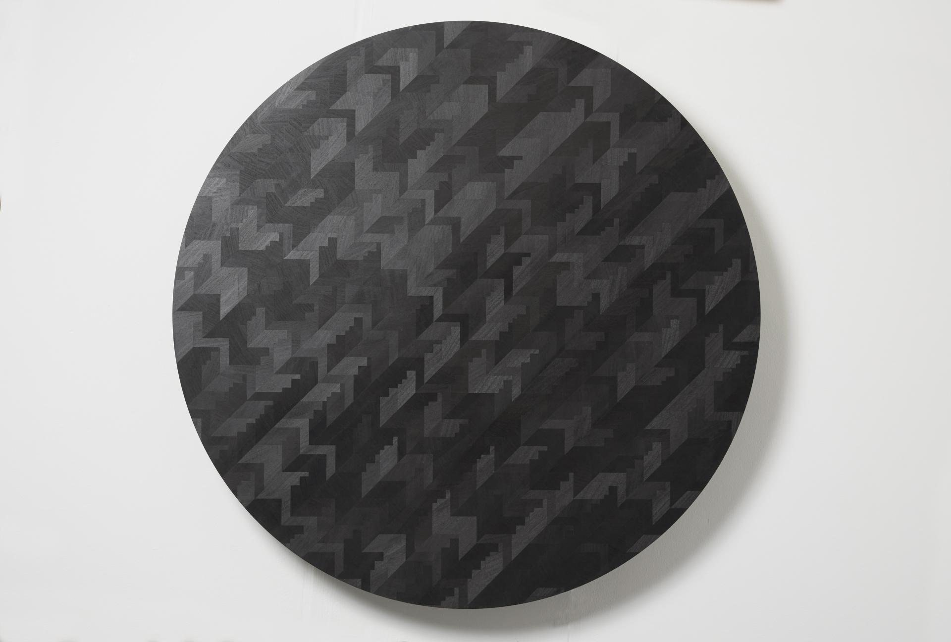 Contemporary round wood artwork with a geometric pattern, showcasing luxury design at the London Design Festival.