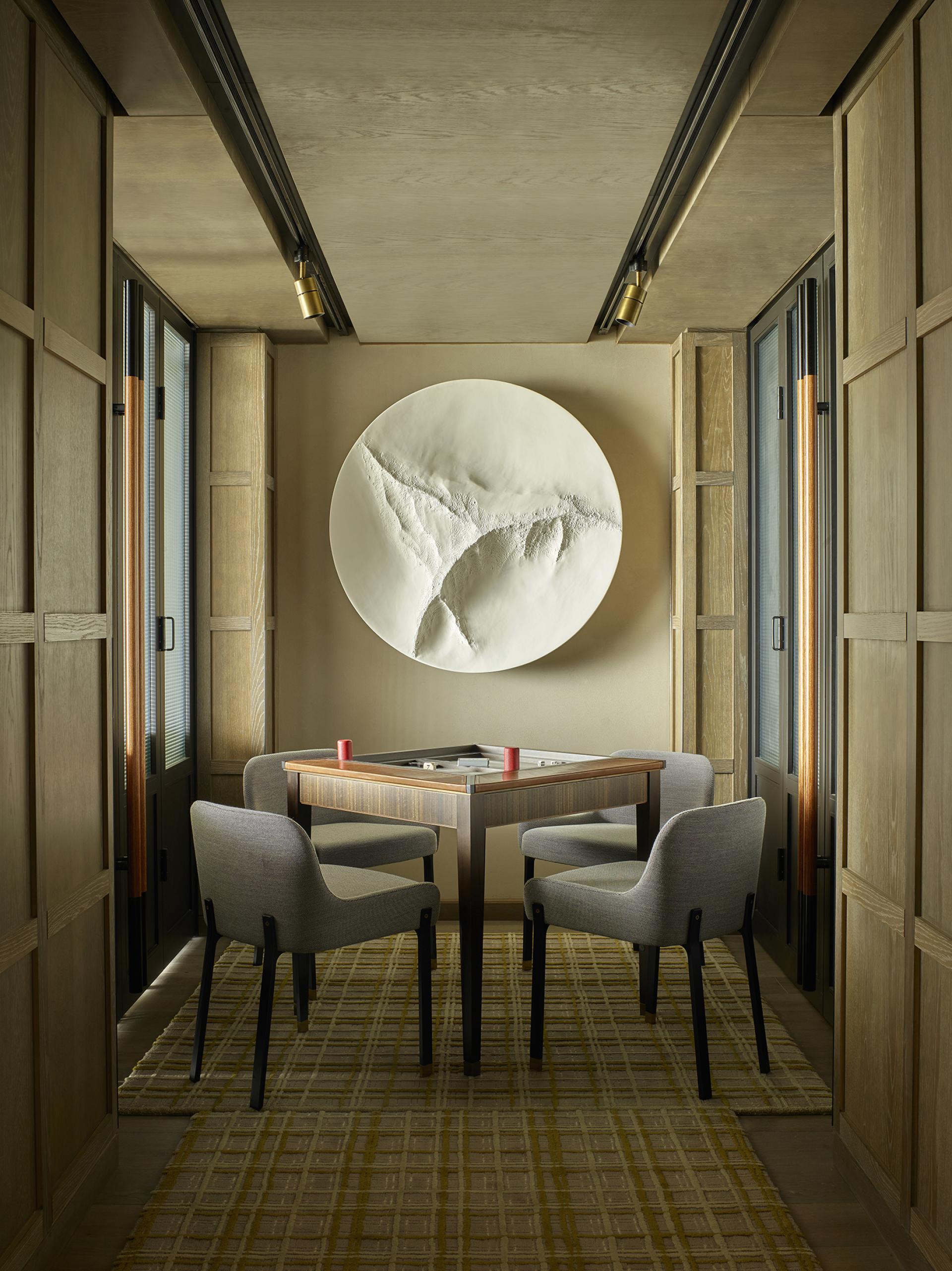 Stylish dining area in a Leicester Square hotel featuring modern furniture, artistic decor, and ambient lighting.