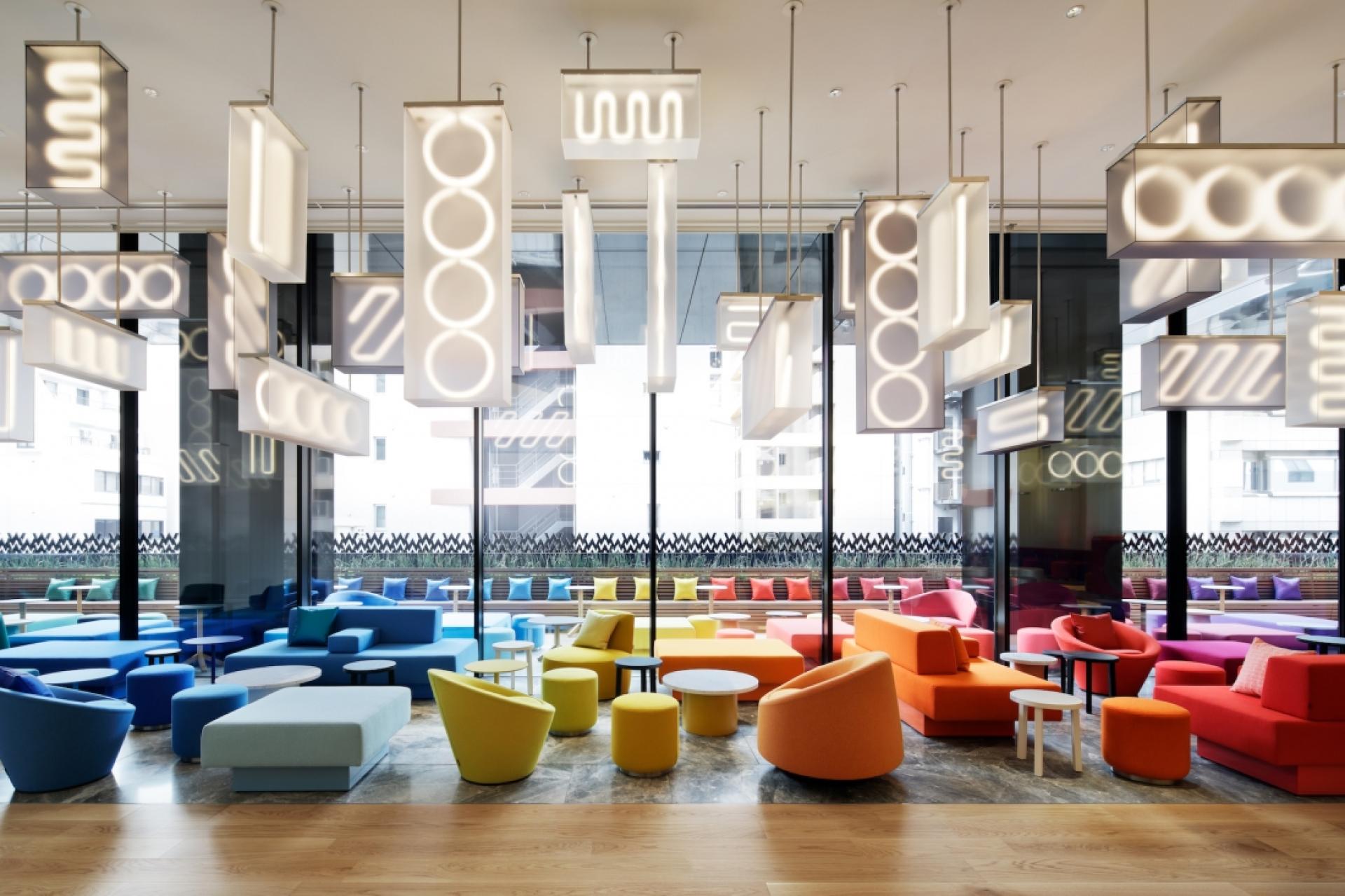 Vibrant interior design featuring colorful seating and unique lighting in a modern hospitality project.
