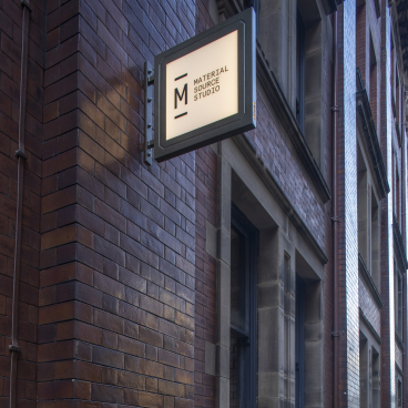 Signage for Material Source Studio displayed on a brick wall, highlighting its role in Scotland's built environment.
