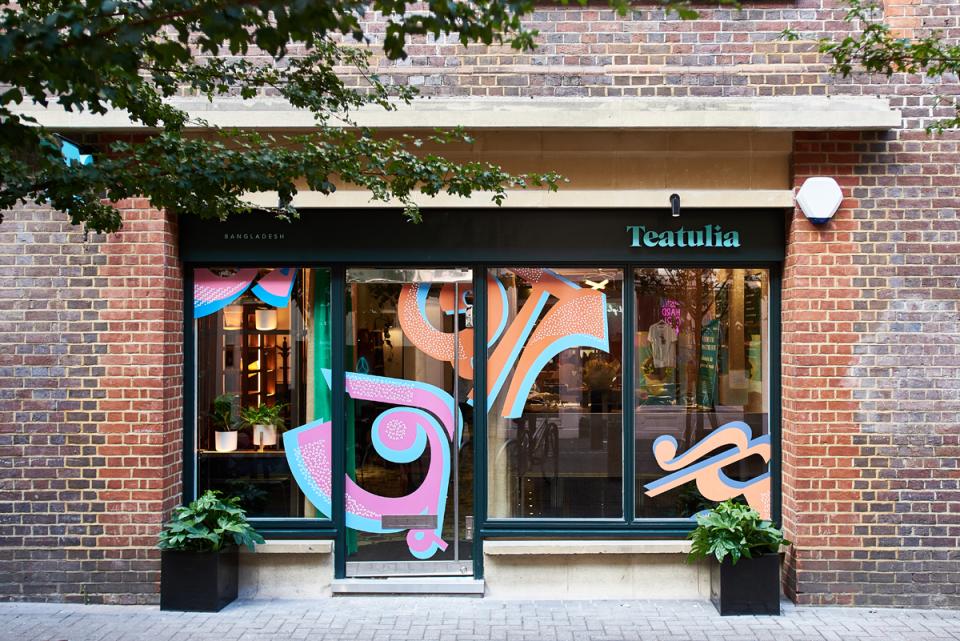 Teatulia's vibrant storefront showcases art deco design elements, inviting customers to the stylish tea shop and cocktail bar.