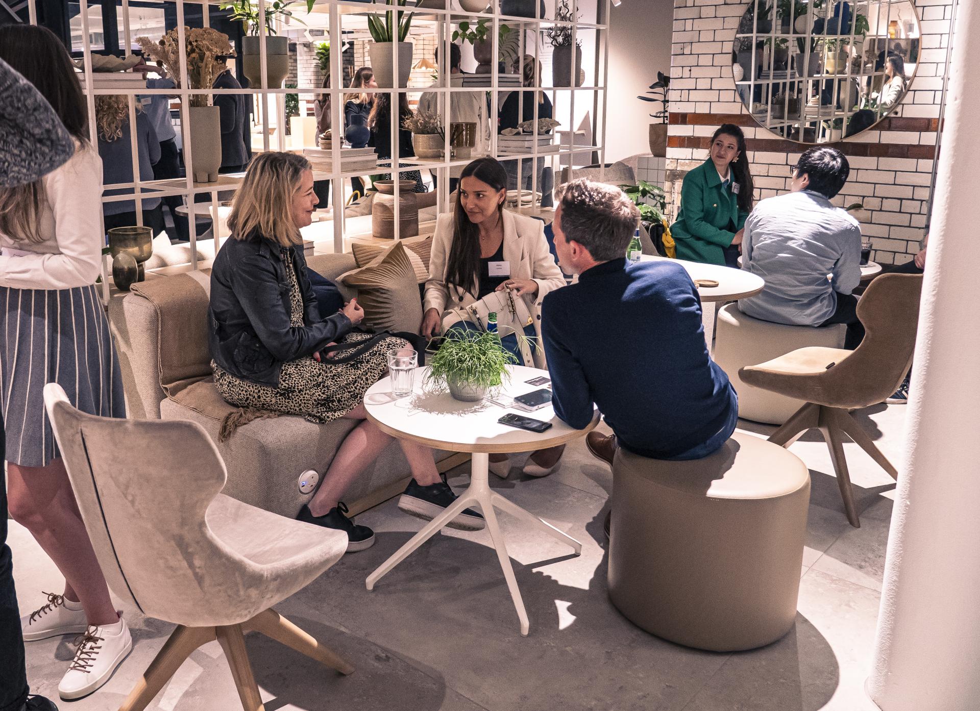 Discussion among experts during the MSS Presents seminar on the Future of Residential, featuring modern furniture and decor.