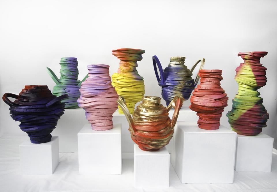 Colorful sculptural vases with twisting shapes displayed on white pedestals, featured in London Craft Week 2024.