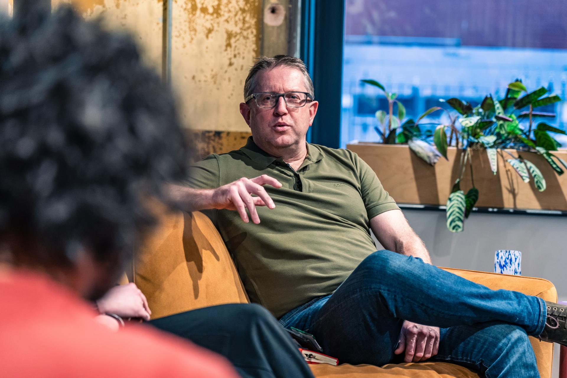 Andrew Bissell speaking on stage at a seminar