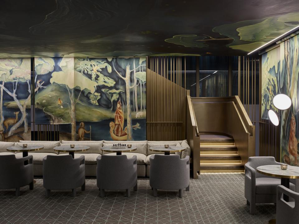 Luxuriously designed hotel lobby featuring dramatic murals and elegant seating at Leicester Square's theatrical Yabu Pushelberg hotel.