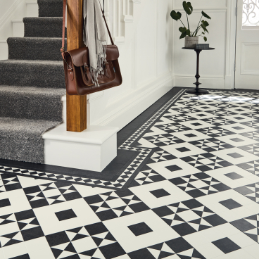 Heritage-inspired black and white tiles showcase a sophisticated Victorian design in a stylish entryway.