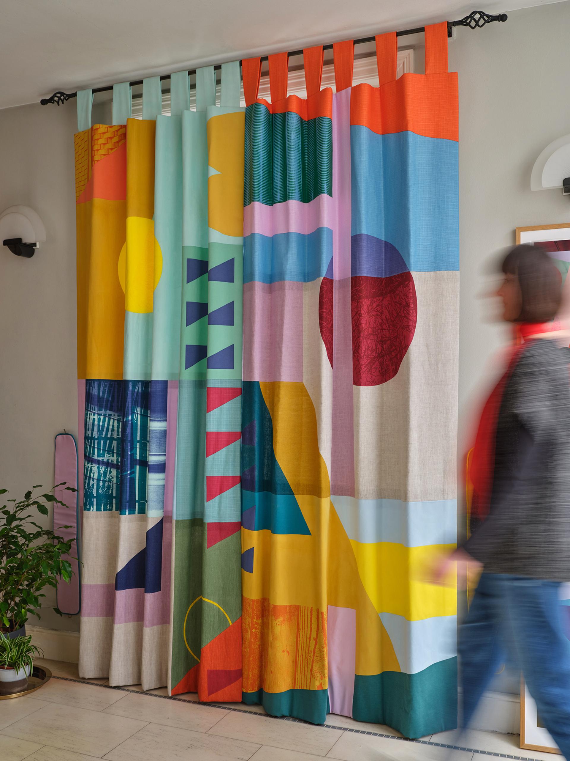 Colorful patterned curtains in a modern interior setting, reflecting contemporary textile design featured at Collect 2025.