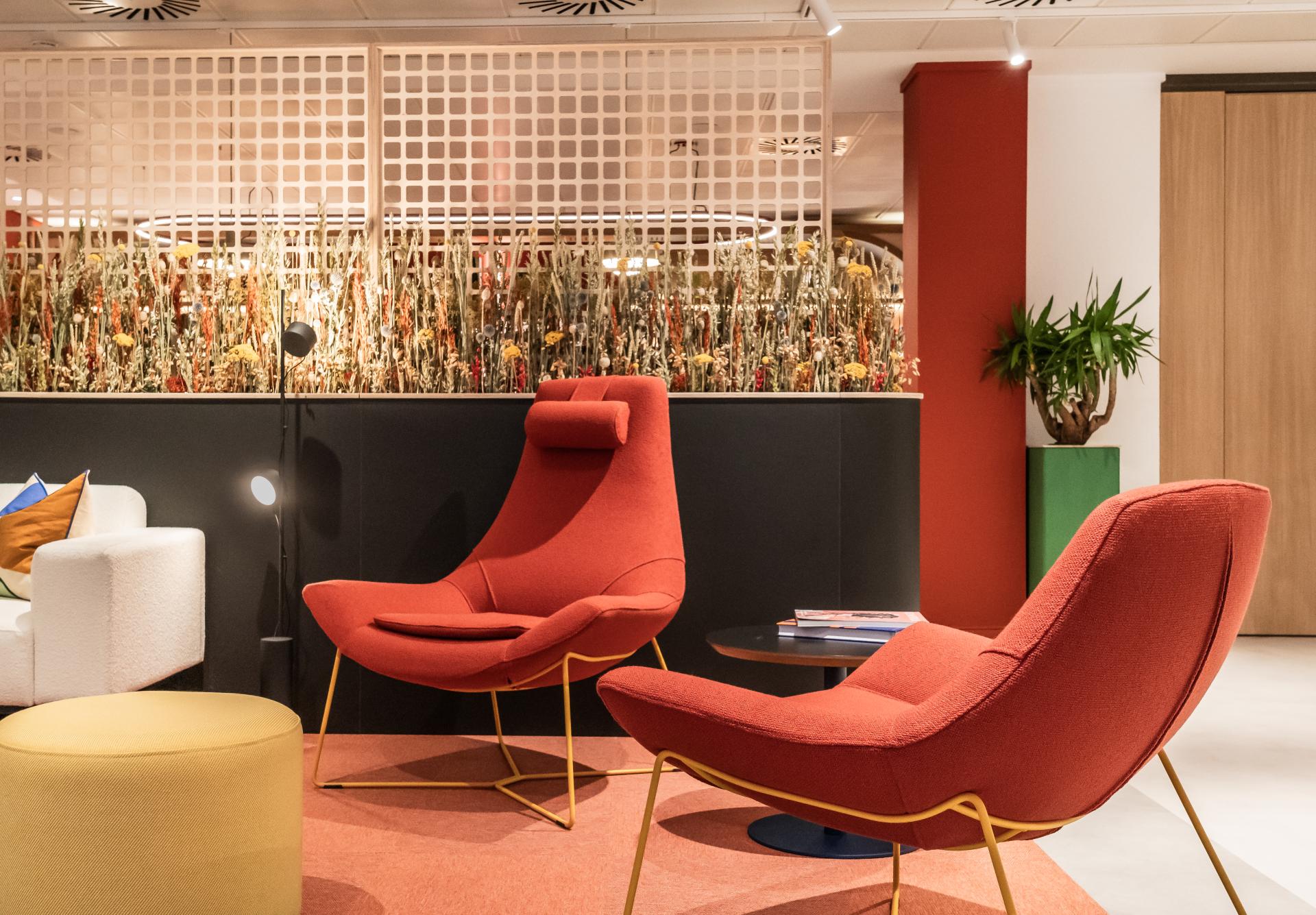 Stylish red chairs with decorative cushions in a modern interior showcasing Scotland's built environment.